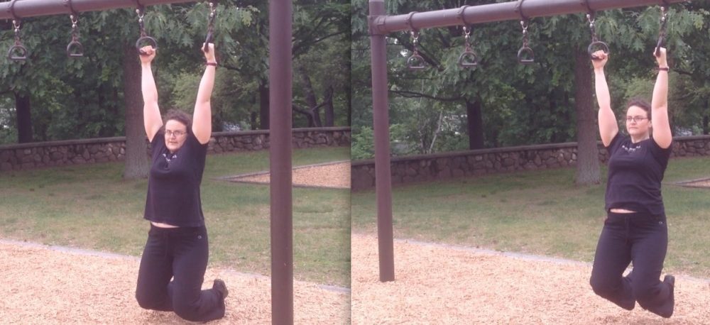 Kat demonstrates the reverse shrugs on the rings.