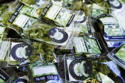 In this photo taken Tuesday, July 1, 2014, packets of a variety of recreational marijuana named "Space Needle" are shown during packaging operations at Sea of Green Farms in Seattle. The grower, the first business licensed to grow recreational marijuana in Washington state, worked all weekend to have supplies ready for stores that were expected to be granted sale licenses on Monday, July 7, the day before legal recreational pot sales begin on July 8. (Ted S. Warren/Associated Press)