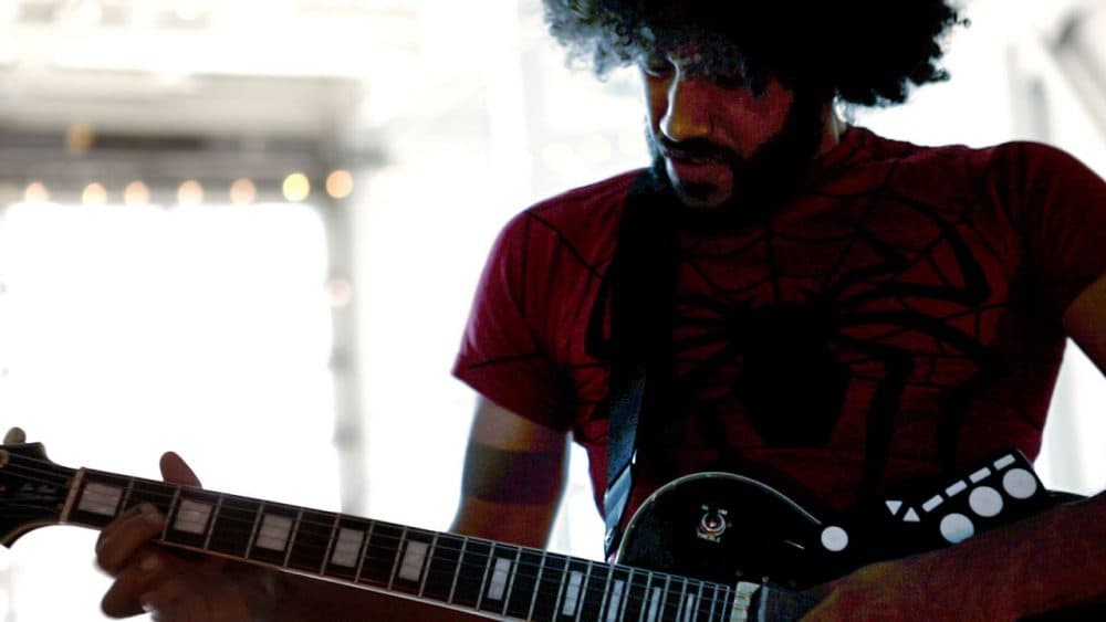 Chris Kazarian performs his "song of the future" at the Artists for Humanity EpiCenter in Boston. (Jesse Costa/WBUR)