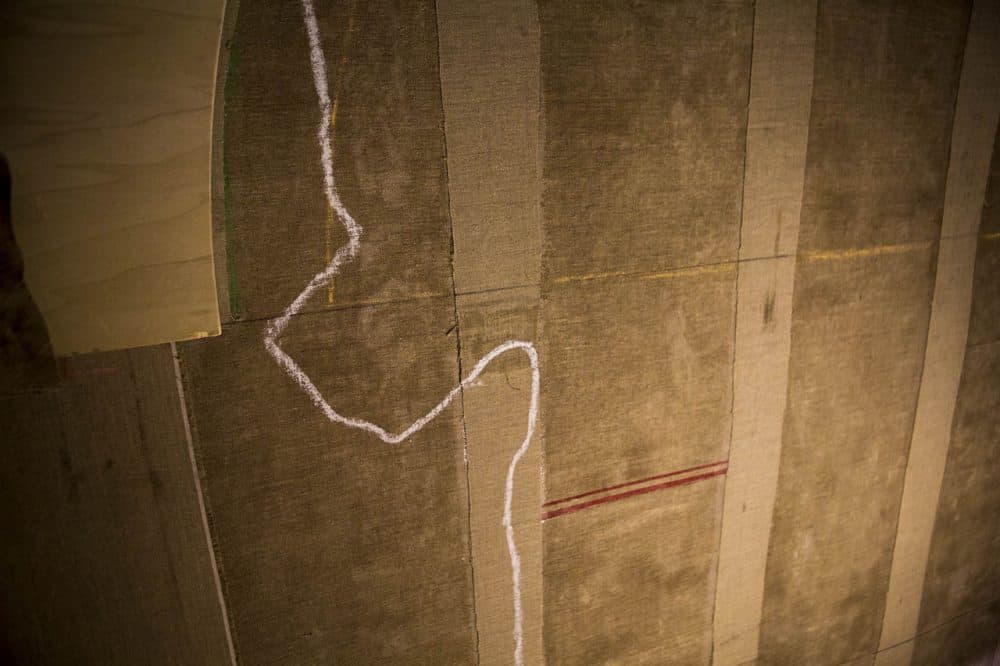 The conservation team mapped the line of damage throughout the mural. (Jesse Costa/WBUR)