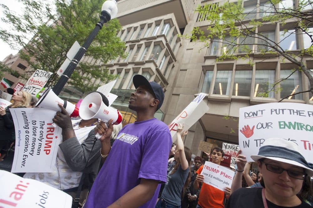Protesters chanted "Donald Trump has got to go" outside The Langham as the presumptive Republican nominee held a midday fundraiser on Wednesday. (Joe Difazio for WBUR)