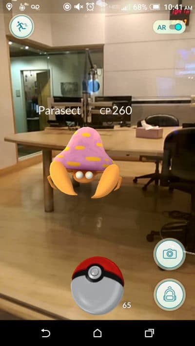 Here & Now producer Dean Russell plays Pokémon GO in the WBUR studio. (James Trout/Here & Now)