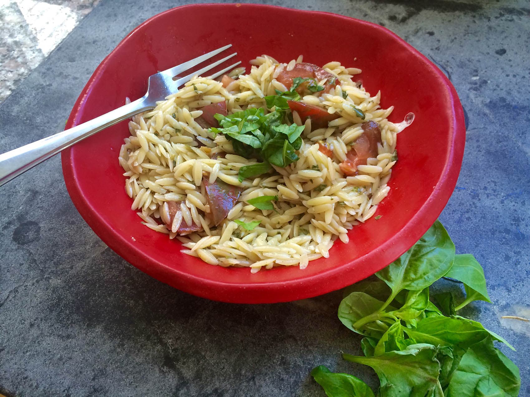A bowl of orzo tossed with Kathy's basil pesto dressing. (Kathy Gunst for Here & Now)
