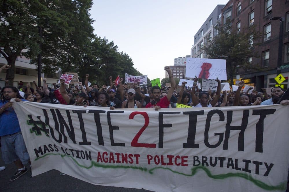 The protest drew a large turnout, with demonstrators marching from Boston police headquarters to Dudley Square. (Joe Difazio for WBUR)