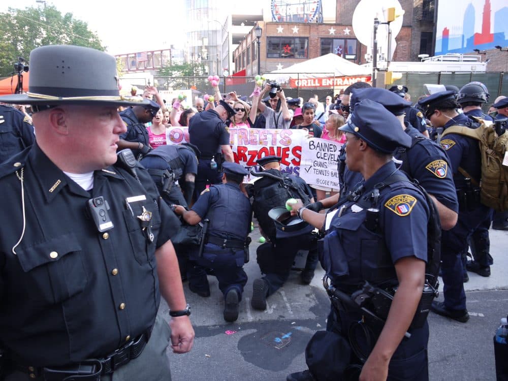 On Tuesday night near Quicken Loans Arena, police confiscated tennis balls that were tossed onto the street by protesters chanting "ban assault weapons, not tennis balls." The demonstrators were speaking out against the security rules for the Republican National Convention, which prohibit tennis balls and other items that authorities says could be used as weapons. Under Open Carry, Ohioans are allowed to carry weapons in public. (Alex Ashlock/Here & Now)