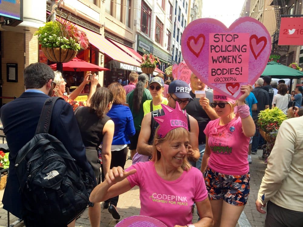 Code Pink volunteers parade down E 4th Ave. in Cleveland promoting women's reproductive rights. (Shannon Dooling/WBUR)