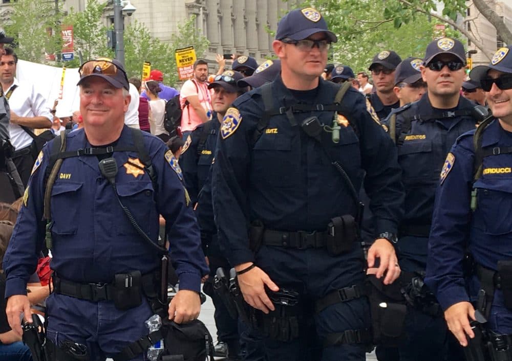 California Highway Patrolman Joe Davy (left) walks through Public Square in Cleveland during a large protest on the last day of the RNC. Davy says his encounters with the public this week were almost always positive. (Shannon Dooling/WBUR)