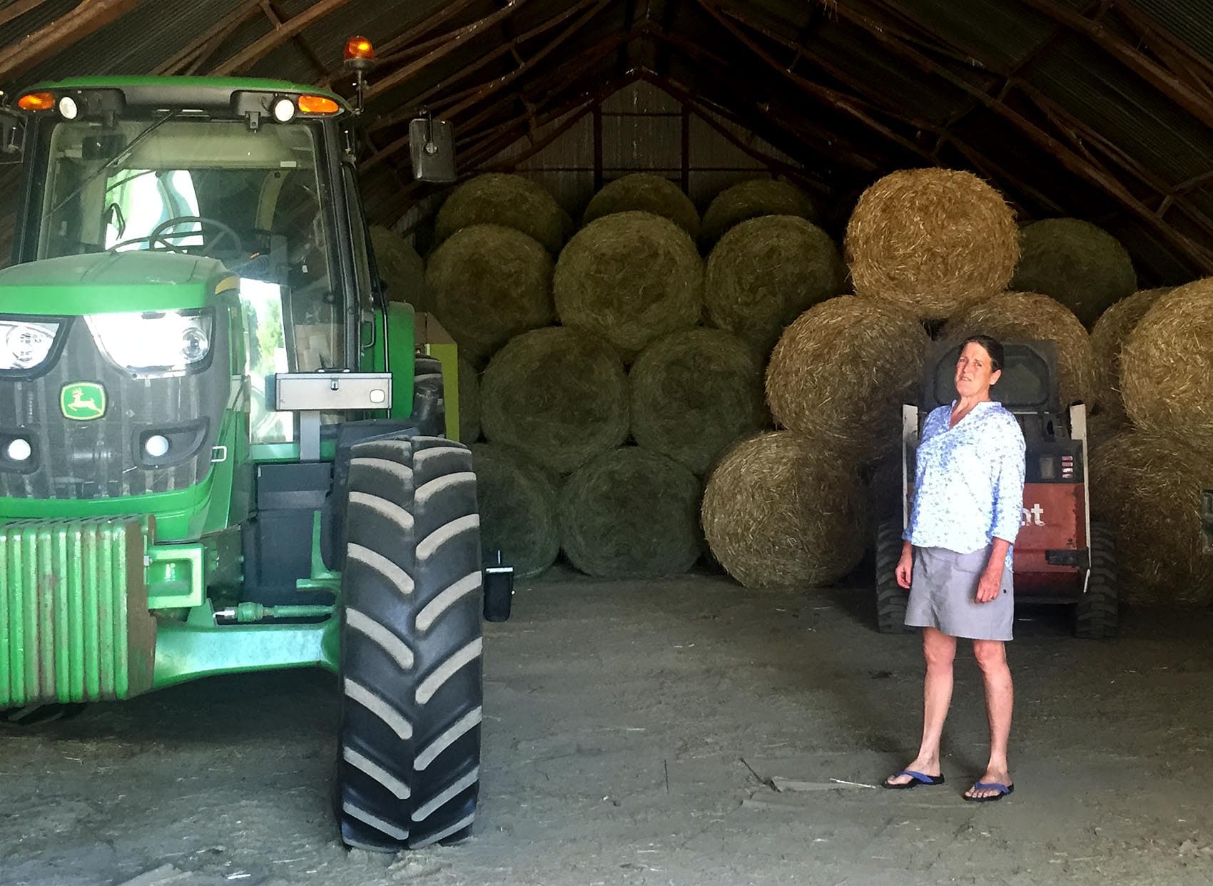 Edie Griffiths stands in the hay barn, where her husband David was injured, on the Seven Stars Farm in Kimberton, Pennsylvania. (Robin Young/Here & Now)