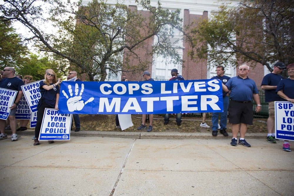 Officers protest in front of Somerville City Hall Thursday night. (Jesse Costa/WBUR)