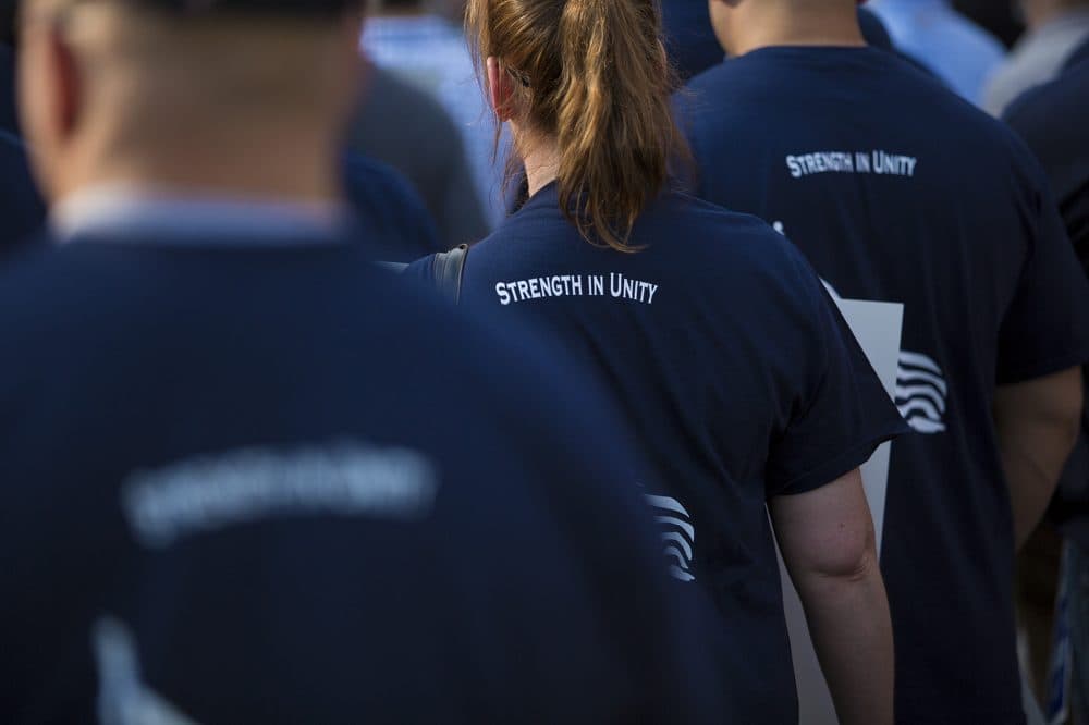 Officers at the rally wore T-shirts with the words "Strength In Unity" on the back. (Jesse Costa/WBUR)