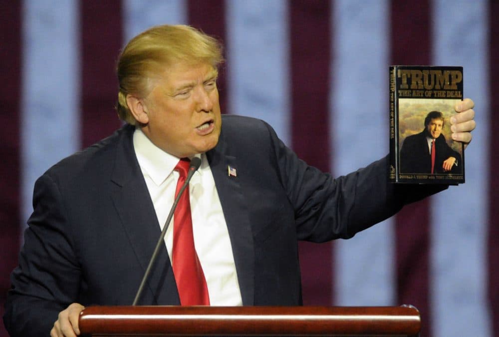 Republican presidential candidate Donald Trump holds up his book "The Art of the Deal," as he speaks during a campaign stop Saturday, Nov. 21, 2015 in Birmingham, Ala. (Eric Schultz/AP)
