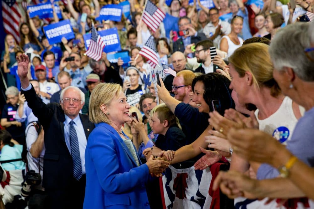 Democratic presidential candidate Hillary Clinton, second from left, arrives with Democratic presidential candidate Sen. Bernie Sanders, I-Vt., left, as Sanders endorses Clinton at a rally at Portsmouth High School in Portsmouth, N.H., Tuesday, July 12, 2016. (Andrew Harnik/AP)