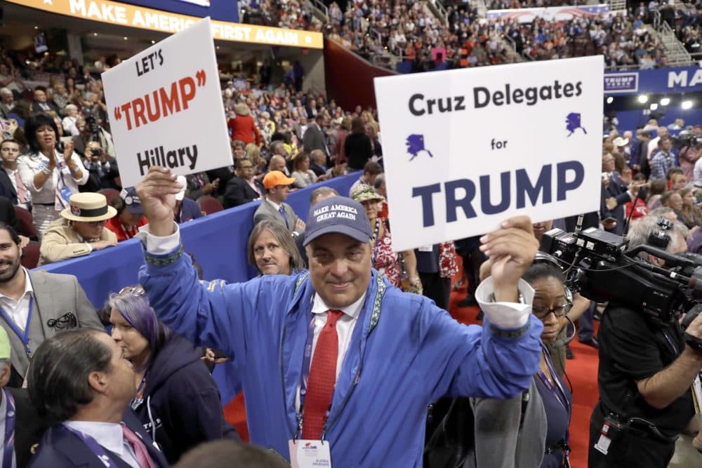 Alaska delegate Nick Stepovich walks around the floor of the Republican National Convention with signs on Wednesday. (Matt Rourke/AP)