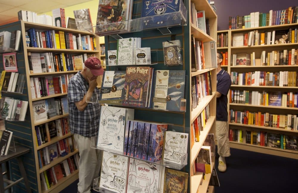 "Harry Potter and the Sorcerer's Stone" (the Scholastic edition) on display at Porter Square Books along with other Potter publications. (Joe Difazio for WBUR)
