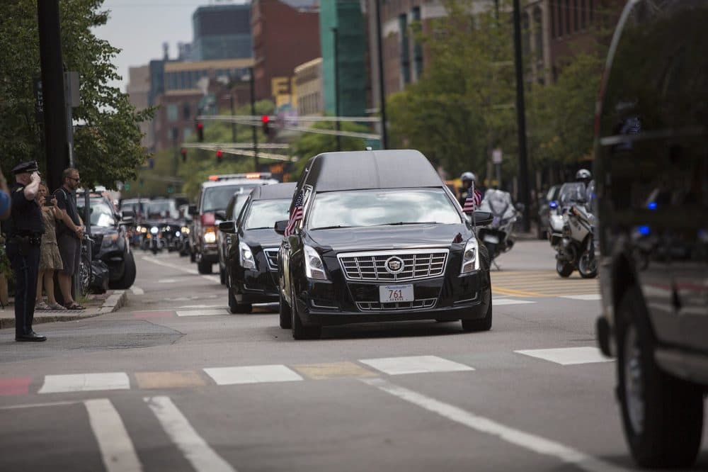 The motorcade carrying the remains of Cpl. Ronald Sparks arrives at Cambridge City Hall Tuesday. (Jesse Costa/WBUR)
