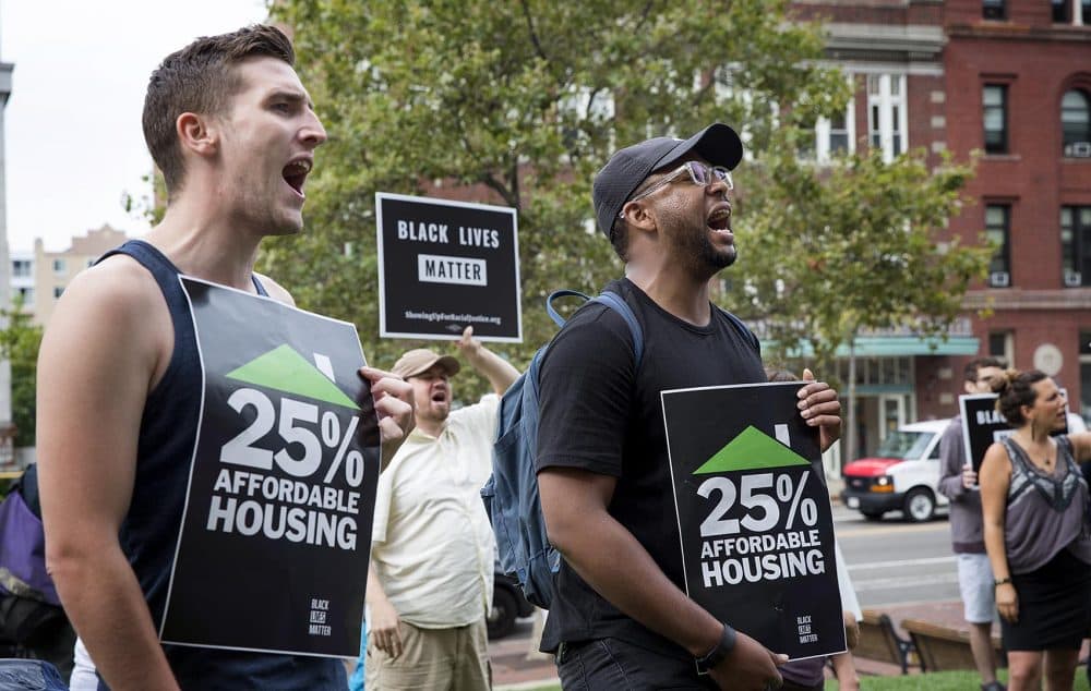 Protesters hold up signs that read "25% affordable housing." (Robin Lubbock/WBUR)