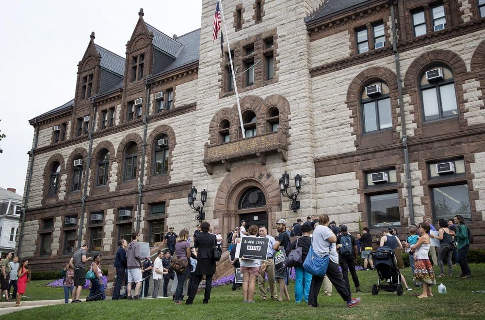 Protesters gather outside Cambridge City Hall Wednesday morning. (Robin Lubbock/WBUR)