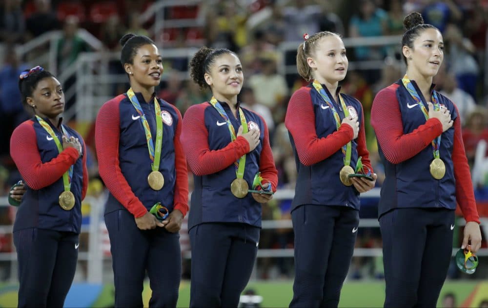 U.S. gymnasts and gold medalists, left to right, Simone Biles, Gabrielle Douglas, Lauren Hernandez, Madison Kocian and Aly Raisman stand for their national anthem during the medal ceremony for the artistic gymnastics women's team at the 2016 Summer Olympics in Rio de Janeiro, Brazil, Tuesday, Aug. 9, 2016. (Julio Cortez/AP)