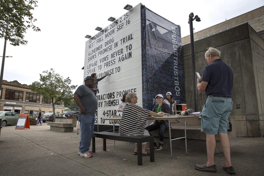 A giant billboard displays promises made in public, at "Public Trust" in Dudley Square, Boston. (Robin Lubbock/WBUR)