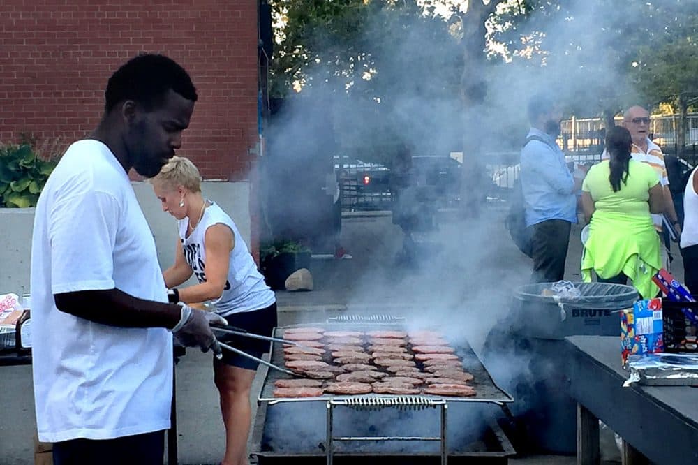The community gathers for a cookout. (Delores Handy/WBUR)