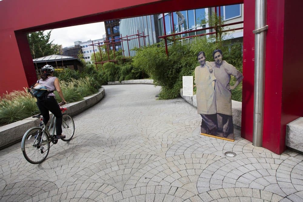 "Two Shopkeepers" stand at the edge of Chinatown Park. (Jesse Costa/WBUR)