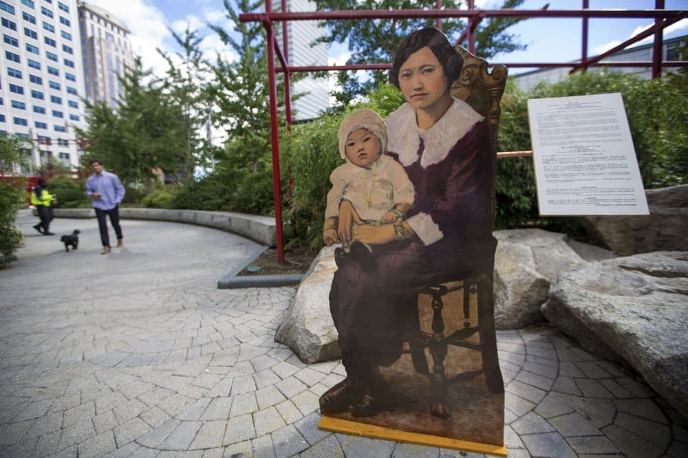 "Mother and Baby" sits at the edge of Chinatown Park, one of artist Wen-Ti Tsen's life-size portraits of residents illustrating the neighborhood's long history. (Jesse Costa/WBUR)