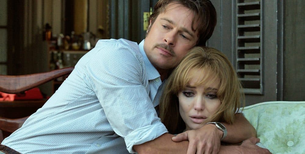 This photo provided by Universal Pictures shows, Brad Pitt, left, as Roland comforting Angelina Jolie Pitt as Vanessa in a scene from the 2015 film "By the Sea," directed by Jolie Pitt. (AP)