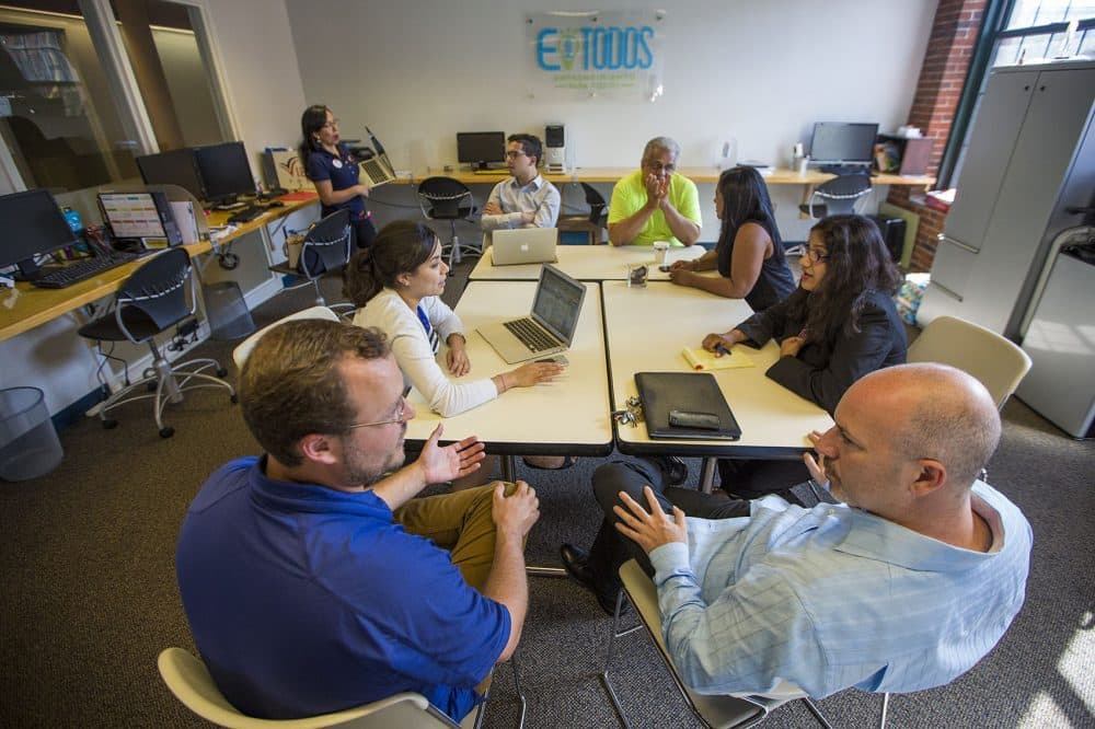 Entrepreneurs, mentors and staff collaborate in Entrepreneurship for All's co-working space in Lawrence. (Jesse Costa/WBUR)