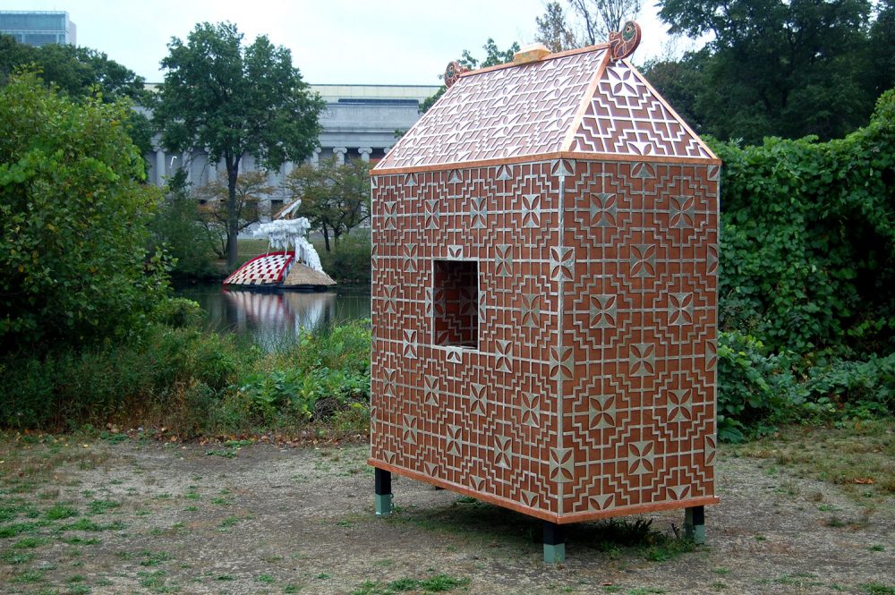 Well House" by Michael Dowling, stands along the shore while Caoimhghin Ó Fraithile's "South of Hy-Brasil" floats in Boston's Back Bay Fens. (Greg Cook/WBUR)