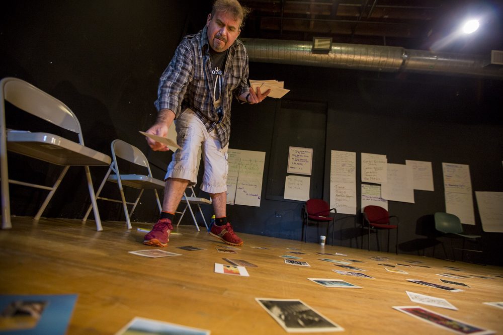 David Gammons drops postcards to suggest ideas for teachers to use in developing their visual interpretations of Shakespeare's "Hamlet." (Jesse Costa/WBUR)