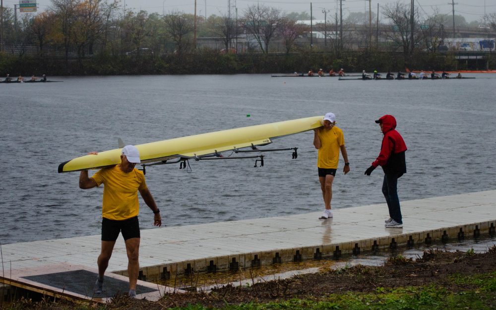 Dale Howard and Bob Blew bring in their boat after racing in the Grand-Master men's 60+ competition. When asked how they did Blew says, "Haven't checked yet, but we finished. We at least got T-shirts." (Elizabeth Gillis/WBUR)