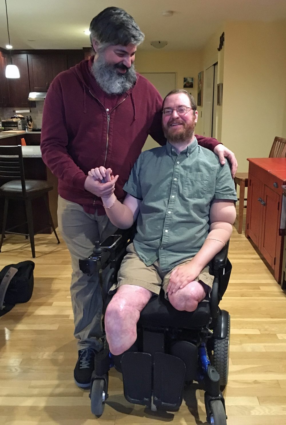 Will Lautzenheiser and his partner Angel Gonzalez at their home in Brookline, Mass. (Samantha Fields/Here & Now)