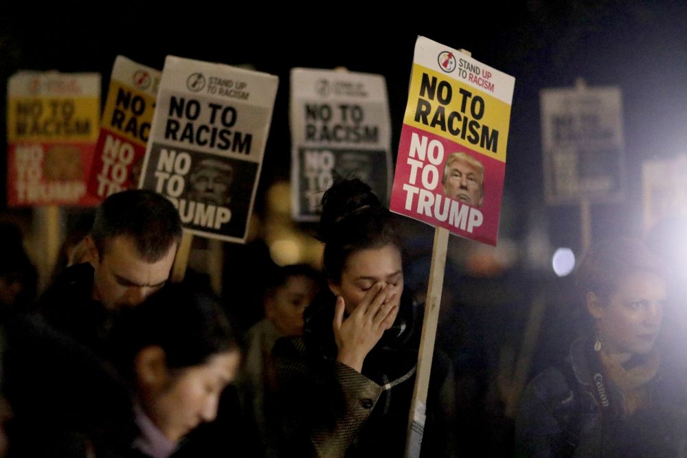 A woman holding a placard wipes away tears as she takes part in an anti-racism protest against President-elect Donald Trump winning the American election, outside the U.S. embassy in London, Wednesday, Nov. 9, 2016. (Matt Dunham/AP)