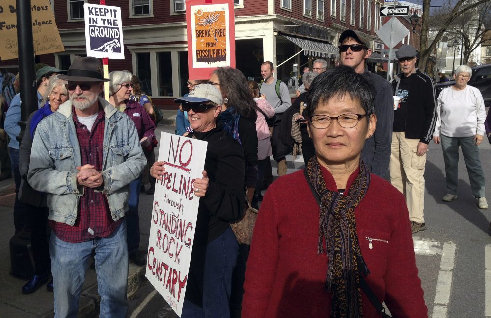Lee Shen, right, spokeswoman for the anti-climate-change group 350-Vermont, participates in a protest of the Dakota Access oil pipeline, with more than 100 people, Tuesday, Nov. 15, 2016, in Montpelier, Vt. (Dave Gram/AP)