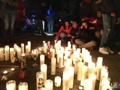 Classmates of Viloria-Paulino huddled together at the vigil. (Shannon Dooling/WBUR)