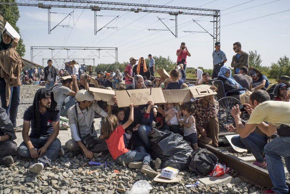 The train station on the Croatian-Serbian border, Sept. 17, 2015. It was over 100 degrees Fahrenheit and thousands of migrants waited for trains to take them to Zagreb, while Croatian riot police kept them fenced in. (Courtesy Peter van Agtmael/Magnum Photos)