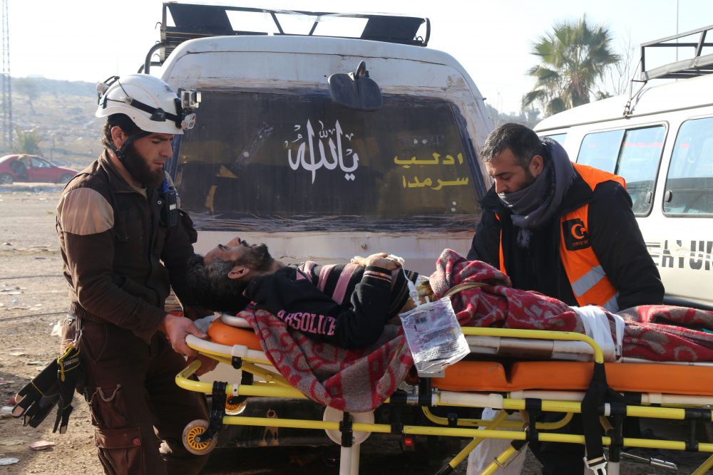 Syrian aid workers carry a man on a stretcher, who was evacuated from the last rebel-held pockets of Syria's northen city of Aleppo, upon arriving on Dec. 20, 2016 in the opposition-controlled Khan al-Assal region, west of the embattled city. (Barra Al-Halabi/AFP/Getty Images)