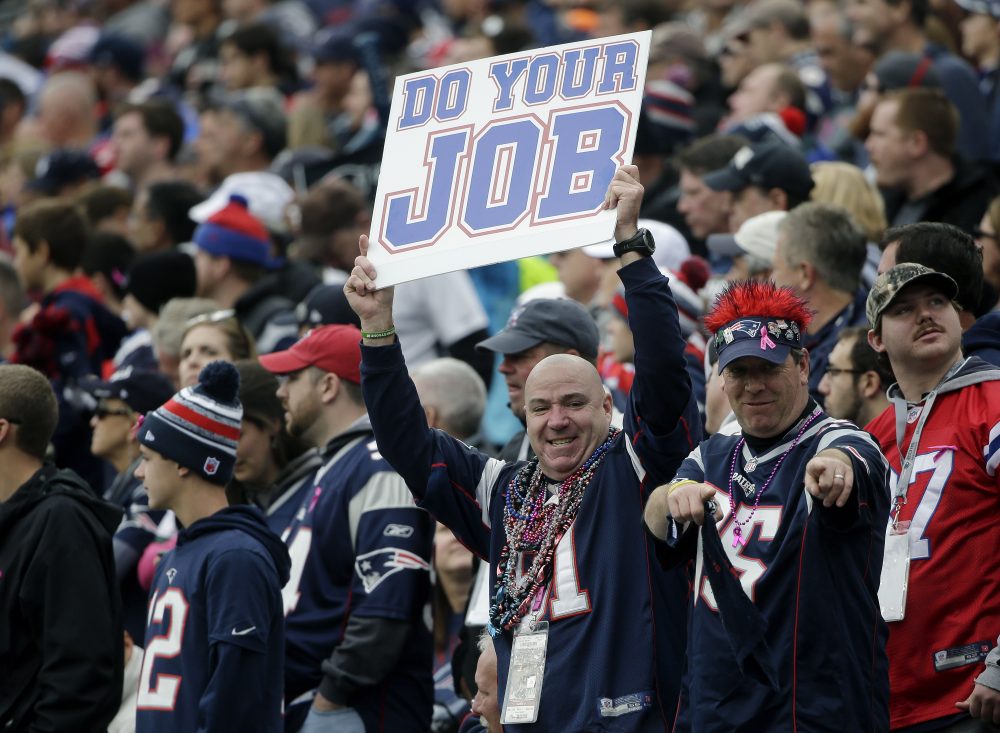 A Patriots fan holds a sign that says "Do your job" during a home game against the Jets on Oct. 25, 2015. (Steven Senne/AP)