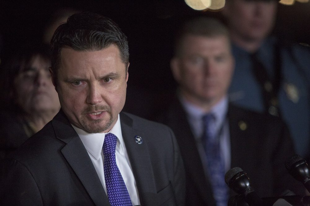Along with state and local police officials, U.S. Marshals Service Deputy Kevin Neal discusses details concerning the capture of wanted fugitive James Morales in Somerville. (Jesse Costa/WBUR)