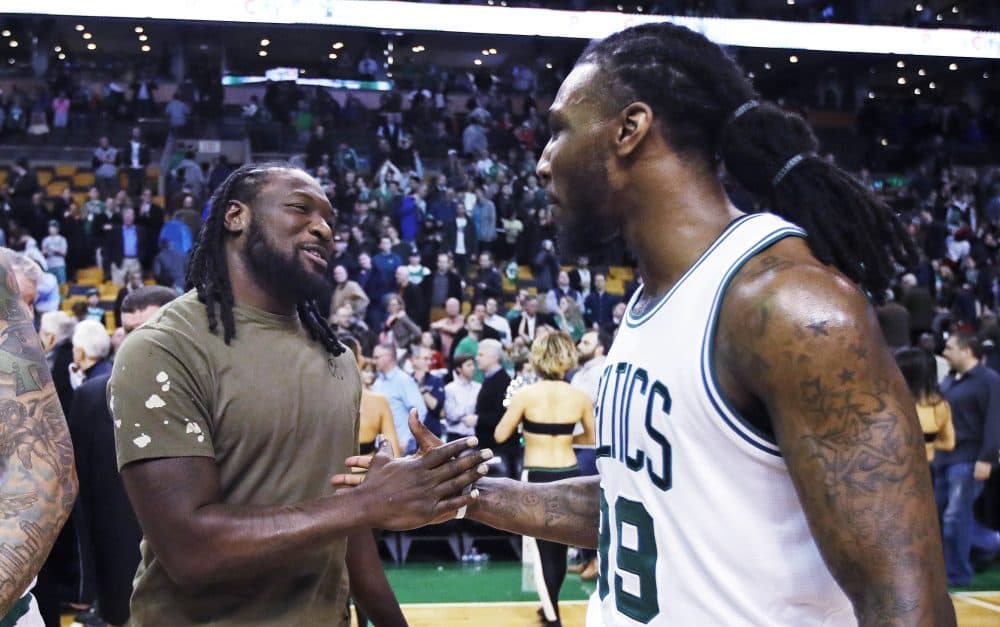 Celtics forward Jae Crowder, right, shakes hands with Patriots running back LeGarrette Blount after an NBA game against the Houston Rockets in Boston. (Charles Krupa/AP)