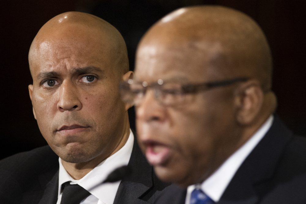 Sen. Cory Booker listens at left as Rep. John Lewis testifies on Capitol Hill on Wednesday, Jan. 11, 2017, during the second day of a confirmation hearing for Attorney General-designate, Sen. Jeff Sessions, before the Senate Judiciary Committee. (Cliff Owen/AP)