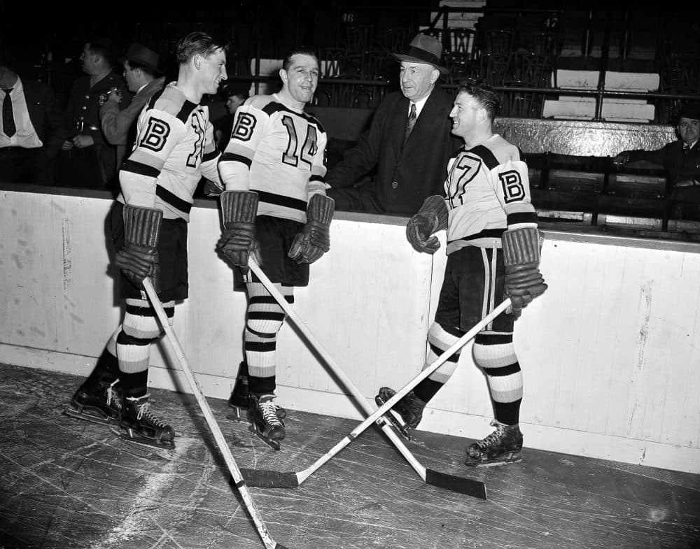 Milt Schmidt, Porky Dumart and Bobby Bauer pictured with Boston Bruins' manager "Uncle Arthur" Ross at practice in Boston Garden on Oct. 23, 1945. (AP File Photo)