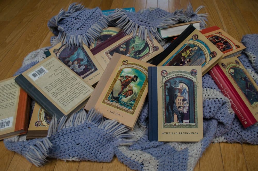 The Brody family editions of "A Series of Unfortunate Events," and the ever-present afghan. (Courtesy of the author)