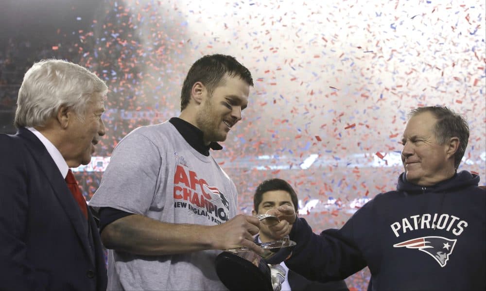 Patriots head coach Bill Belichick, right, passes the AFC Championship trophy to quarterback Tom Brady after beating the Pittsburgh Steelers, Sunday in Foxborough. At left is team owner Robert Kraft. The Patriots defeated the the Steelers 36-17 to advance to the Super Bowl. (Charles Krupa/AP)
