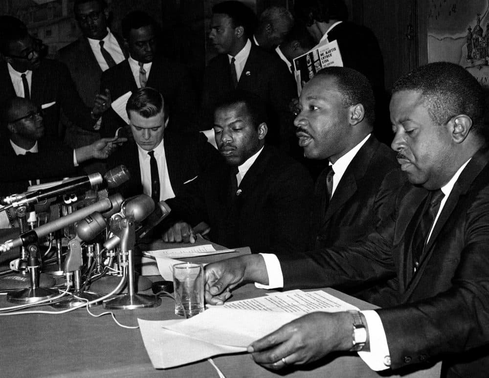 In this April 2, 1965 file photo, Dr. Martin Luther King Jr., second from right, speaks at a news conference next to John Lewis, to his left, chairman of the Student Nonviolent Coordinating Committee, in Baltimore. (William A. Smith/AP)
