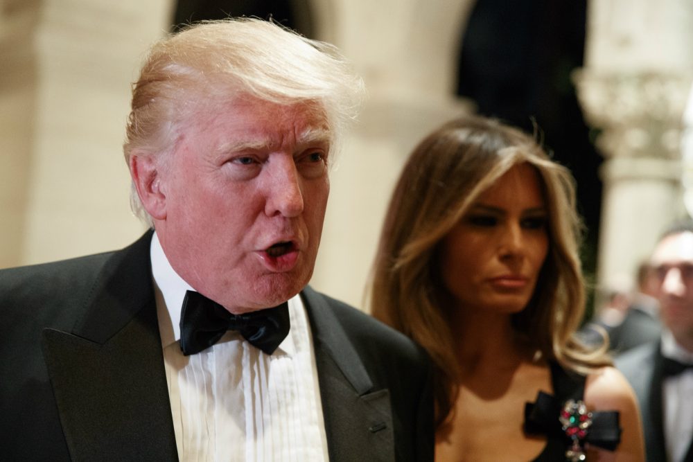 Melania Trump, right, looks on as her husband President-elect Donald Trump talks to reporters during a New Year's Eve party at Mar-a-Lago, Saturday, Dec. 31, 2016, in Palm Beach, Fla. (Evan Vucci/AP)