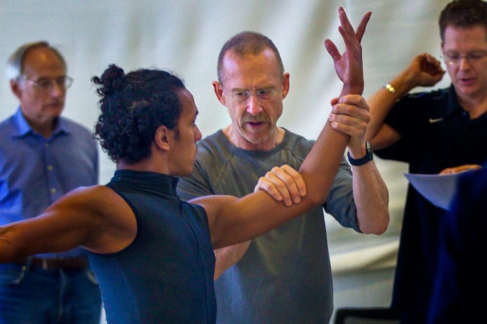 Choreographer William Forsythe, instructs a dancer through a pose during a rehearsal for "Artifact," which has it's Boston premiere on February 23, 2017 at the Boston Opera House. (Jesse Costa/WBUR)