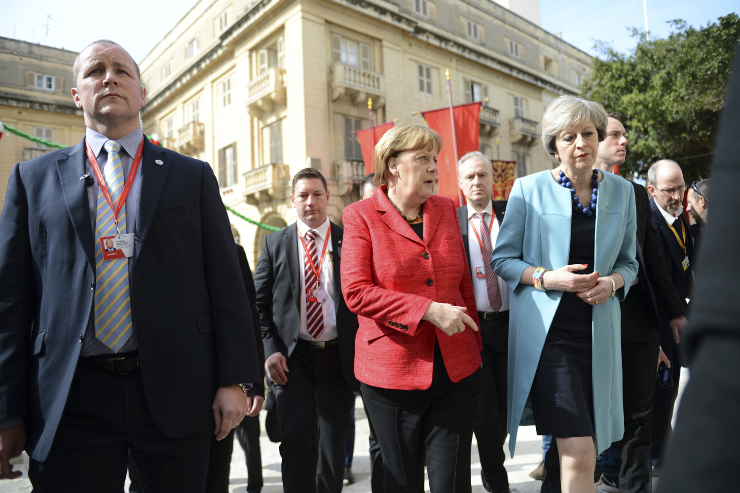 German Chancellor Angela Merkel, center, speaks with British Prime Minister Theresa May, right, as they walk with other EU leaders during an event at an EU summit in Valletta, Malta. (Rene Rossignaud/AP)