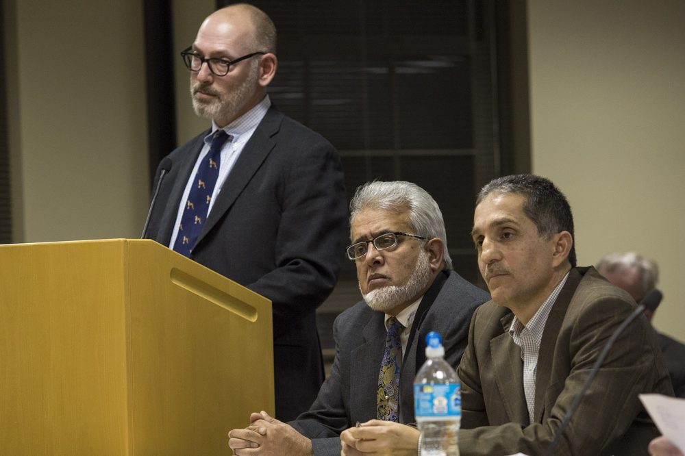 From left, attorney Jay Talerman, Dr. Khalid Khan Sadozai and Imad Zrein, representatives of the Islamic Society of Greater Worcester, are dumbfounded after the Dudley zoning board's initial vote to reject the application for the proposed cemetery last year. (Jesse Costa/WBUR)