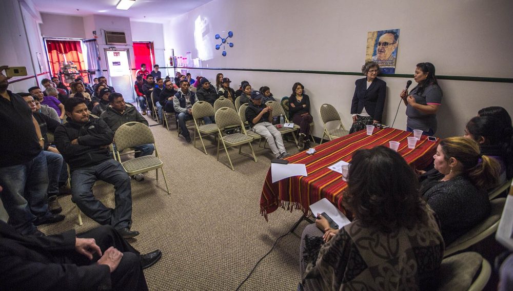 Juana Garcia tells the audience of New Bedford community members about her experiences being detained by immigration officials after the Michael Bianco factory raid. (Jesse Costa/WBUR)